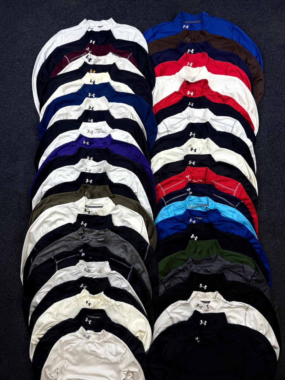 under armour compression t shirts laid out in multiple colours for fitness