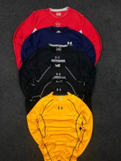 yellow Under Armour compression t shirt front with layered black and blue shirts behind